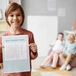 Child showing his results in English