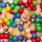 Happy boy playing with balls