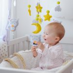 a-cute-baby-sitting-in-a-crib-curiously-playing-wi-2024-10-18-01-43-45-utc